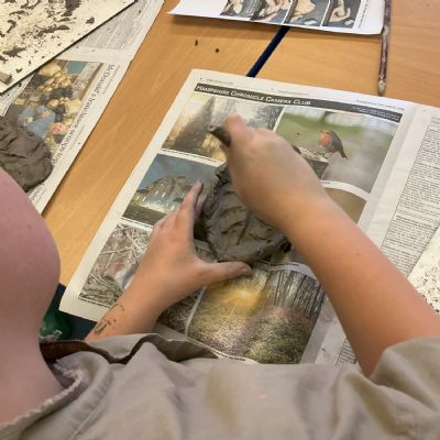 Children making clay lizards